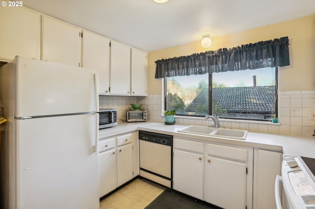 kitchen featuring white cabinetry, sink, white appliances, and backsplash