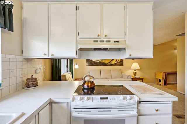 kitchen with kitchen peninsula, white electric range, white cabinets, and decorative backsplash