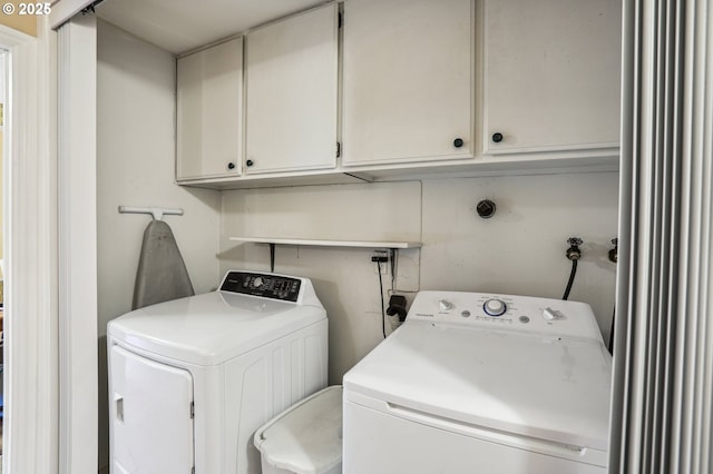 laundry room featuring cabinets and washer and dryer