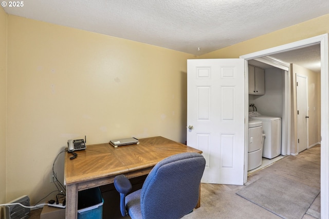 office featuring light colored carpet, independent washer and dryer, and a textured ceiling