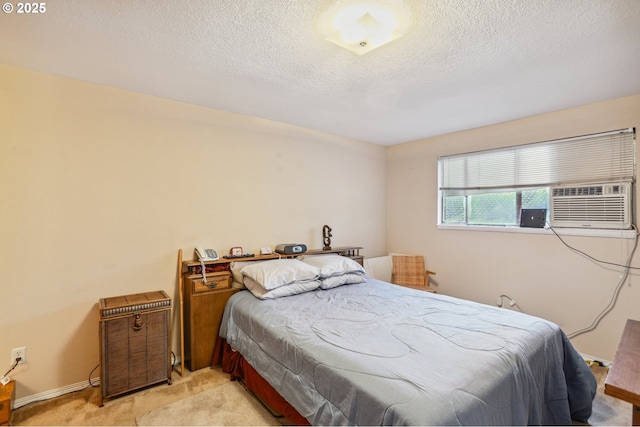 bedroom featuring light carpet and a textured ceiling