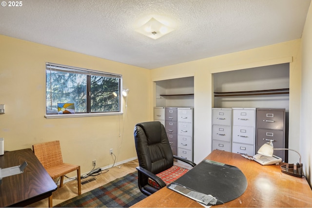 office area with a textured ceiling and light hardwood / wood-style flooring