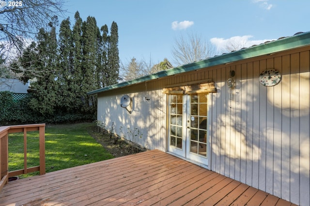 wooden terrace with french doors and a yard