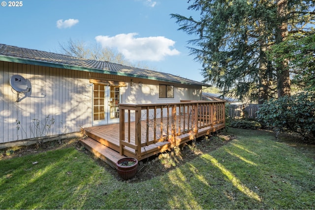 wooden deck featuring a lawn