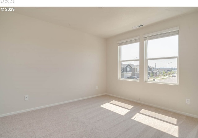 empty room with light colored carpet