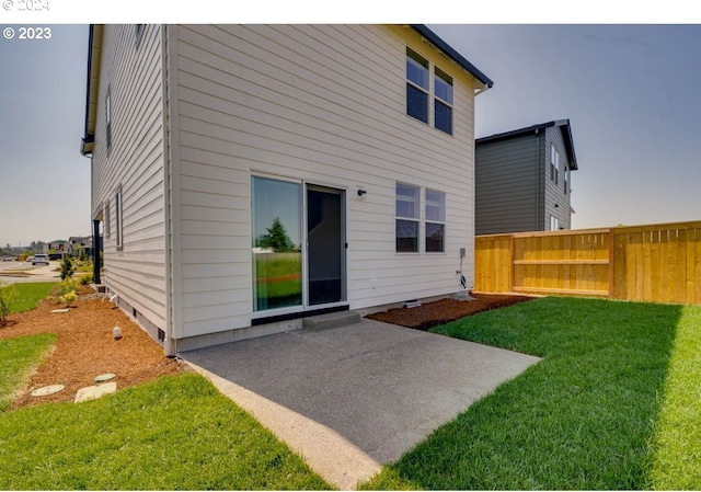 back of house with a yard and a patio area