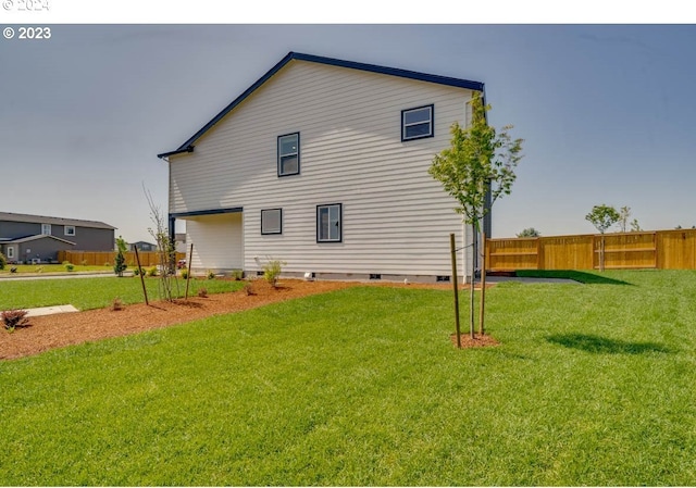 rear view of property featuring a lawn