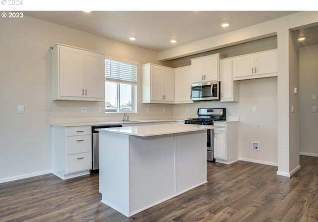 kitchen featuring stainless steel appliances, a kitchen island, and white cabinets