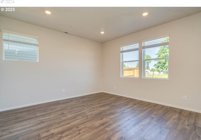 spare room with dark hardwood / wood-style flooring