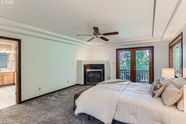 23535 SW Newland Rd, Wilsonville, OR 97070 - bedroom featuring a raised ceiling, access to exterior, a glass covered fireplace, carpet, and french doors