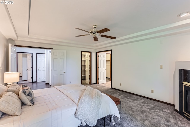 23535 SW Newland Rd, Wilsonville, OR 97070 - bedroom featuring a tray ceiling, carpet, a ceiling fan, and a walk in closet