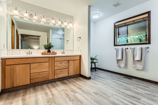 23535 SW Newland Rd, Wilsonville, OR 97070 - full bathroom featuring double vanity, wood finished floors, and a shower with door