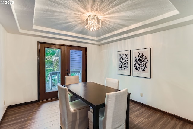 23535 SW Newland Rd, Wilsonville, OR 97070 - dining area featuring a raised ceiling, a chandelier, wood finished floors, and french doors