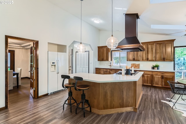 23535 SW Newland Rd, Wilsonville, OR 97070 - kitchen with white fridge with ice dispenser, island exhaust hood, brown cabinetry, dark wood finished floors, and light countertops