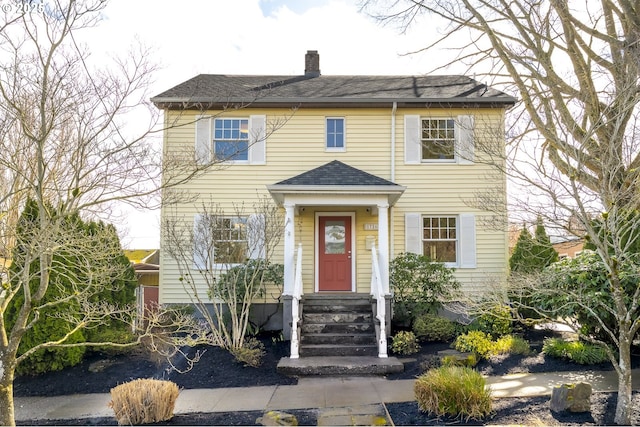 colonial-style house with a chimney