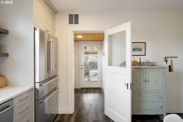 kitchen with visible vents, baseboards, light countertops, stainless steel appliances, and dark wood-style flooring