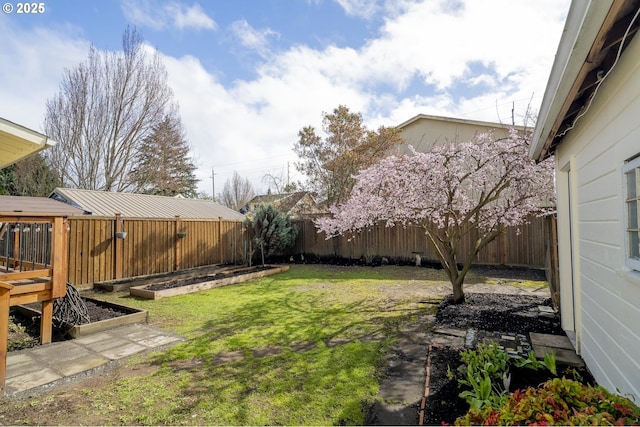 view of yard with a vegetable garden and a fenced backyard