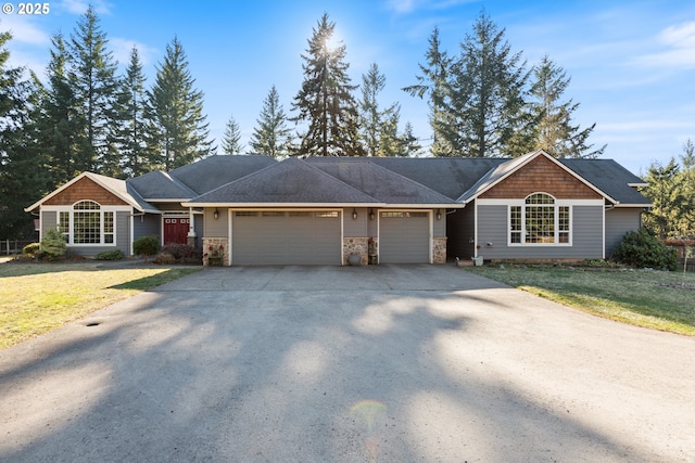 24150 NW Green Mountain Rd, Banks, OR 97106 - ranch-style house with an attached garage, stone siding, a front lawn, and concrete driveway