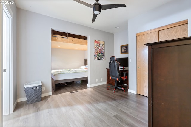 24150 NW Green Mountain Rd, Banks, OR 97106 - bedroom with wood finished floors, baseboards, an office area, and a ceiling fan