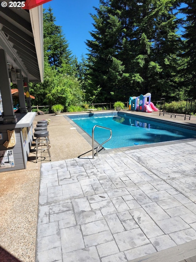 24150 NW Green Mountain Rd, Banks, OR 97106 - swimming pool featuring a patio area and view of wooded area