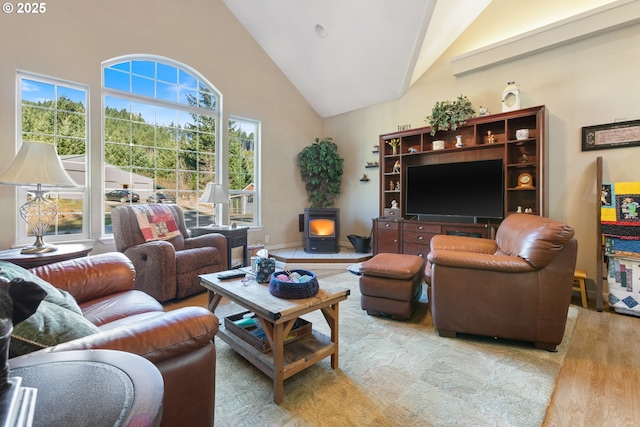 24150 NW Green Mountain Rd, Banks, OR 97106 - living area with wood finished floors, high vaulted ceiling, and a wood stove