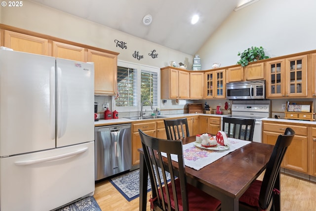 24150 NW Green Mountain Rd, Banks, OR 97106 - kitchen featuring stainless steel appliances, a sink, high vaulted ceiling, light wood-style flooring, and light countertops