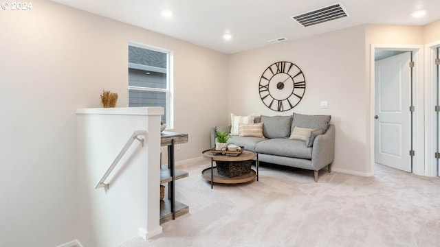 sitting room with light carpet, visible vents, baseboards, an upstairs landing, and recessed lighting