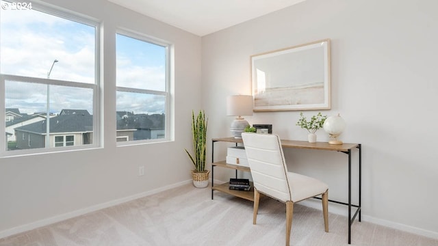 carpeted office featuring baseboards