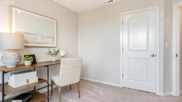 carpeted office space featuring visible vents and baseboards