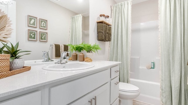 bathroom with vanity, toilet, and shower / bath combo with shower curtain