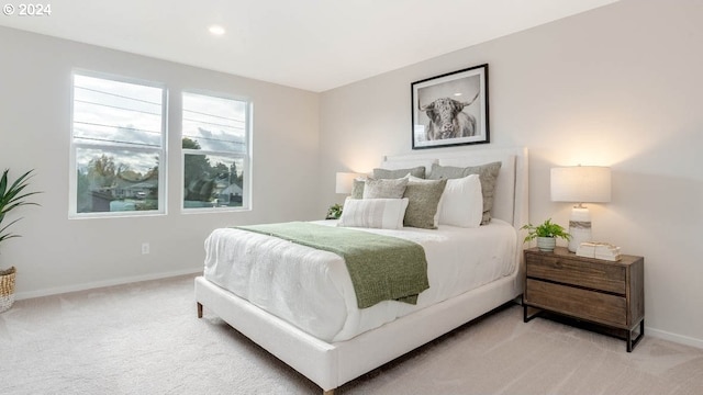 bedroom with recessed lighting, light colored carpet, and baseboards