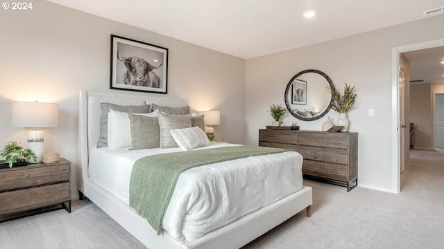 carpeted bedroom featuring visible vents and baseboards