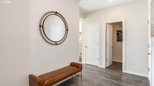 hallway with stairway, baseboards, and wood finished floors