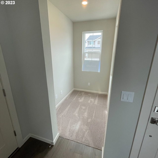 empty room featuring baseboards and wood finished floors