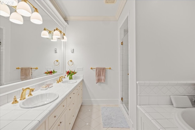 bathroom featuring crown molding, a sink, a shower stall, and tile patterned floors