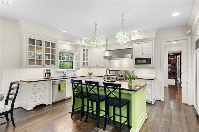 kitchen with a breakfast bar area, a sink, wall chimney range hood, black microwave, and dishwasher