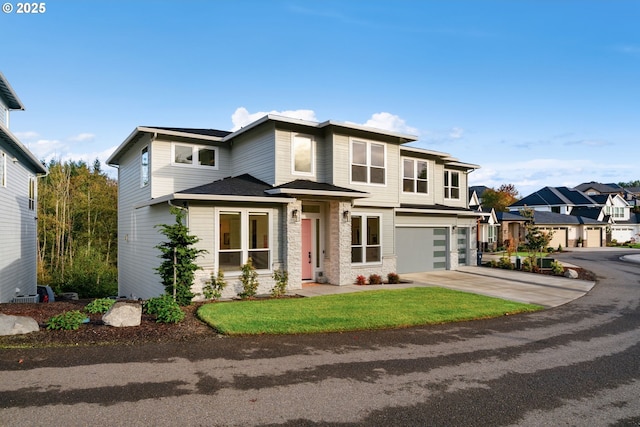 prairie-style home featuring a garage, stone siding, a residential view, and concrete driveway