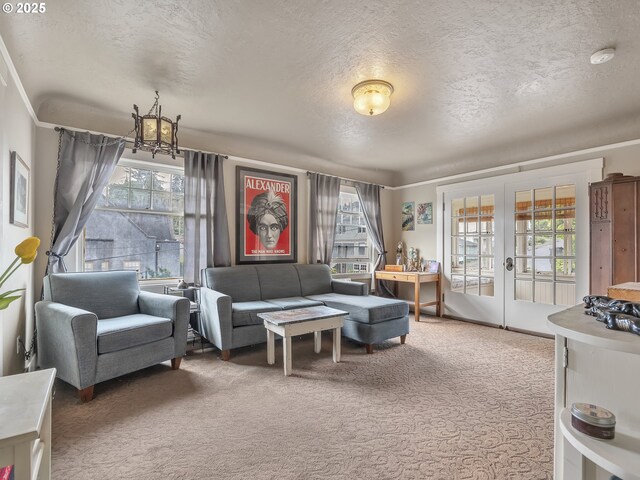 1078 Harrison Ave, Astoria, OR 97103 - carpeted living room with a textured ceiling, french doors, and a chandelier