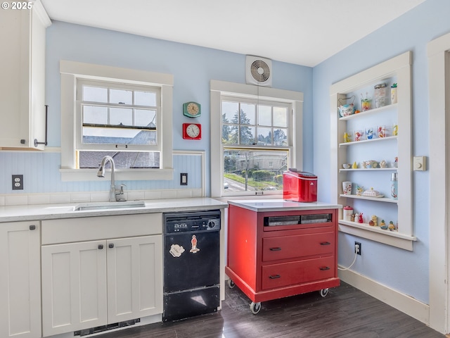 1078 Harrison Ave, Astoria, OR 97103 - kitchen with black dishwasher, a sink, dark wood-style floors, and light countertops