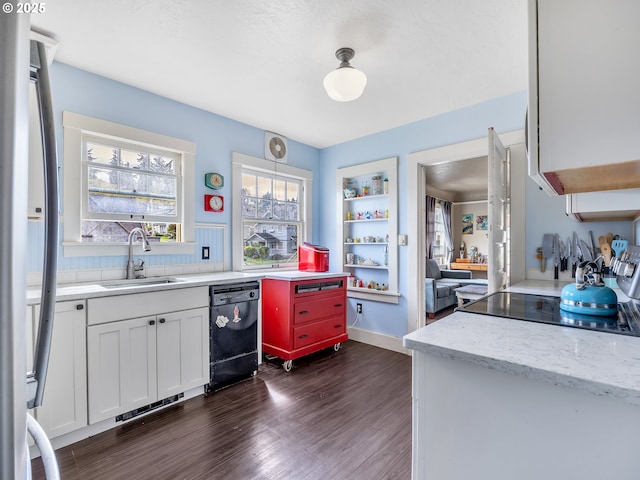 1078 Harrison Ave, Astoria, OR 97103 - kitchen with dishwasher, a sink, dark wood finished floors, white cabinetry, and freestanding refrigerator