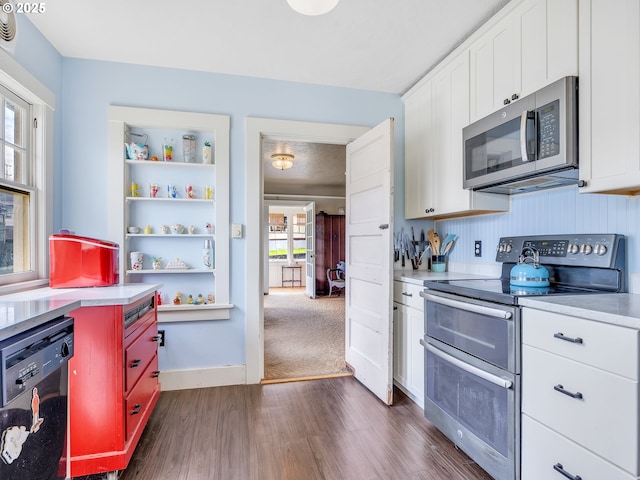 1078 Harrison Ave, Astoria, OR 97103 - kitchen featuring appliances with stainless steel finishes, dark wood finished floors, light countertops, and open shelves