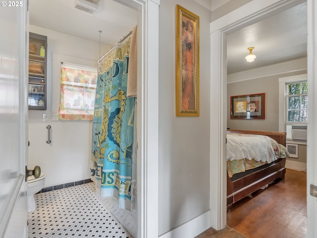 1078 Harrison Ave, Astoria, OR 97103 - bathroom featuring toilet, a shower with shower curtain, cooling unit, baseboards, and connected bathroom