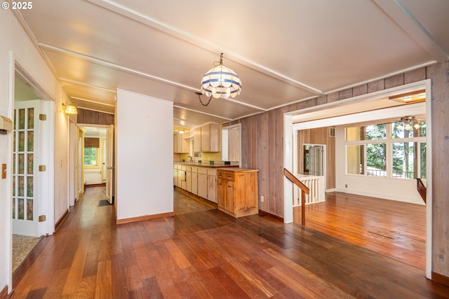 32468 Dillard Rd, Eugene, OR 97405 - unfurnished living room with a chandelier, dark wood-style flooring, wood walls, and healthy amount of natural light
