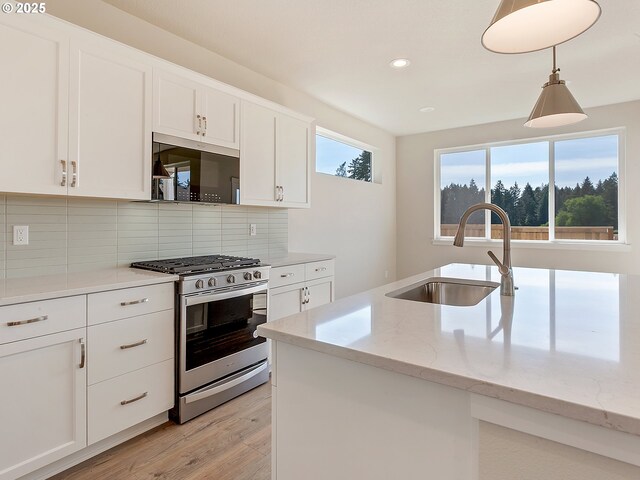 13863 SW Sabrina Ave, Tigard, OR 97140 - kitchen featuring stainless steel gas range, a sink, light wood-style flooring, recessed lighting, and backsplash