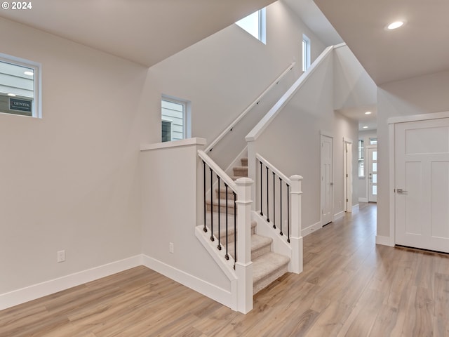 stairs with hardwood / wood-style floors