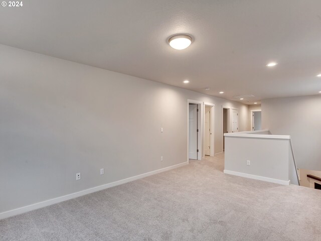 carpeted empty room featuring a textured ceiling