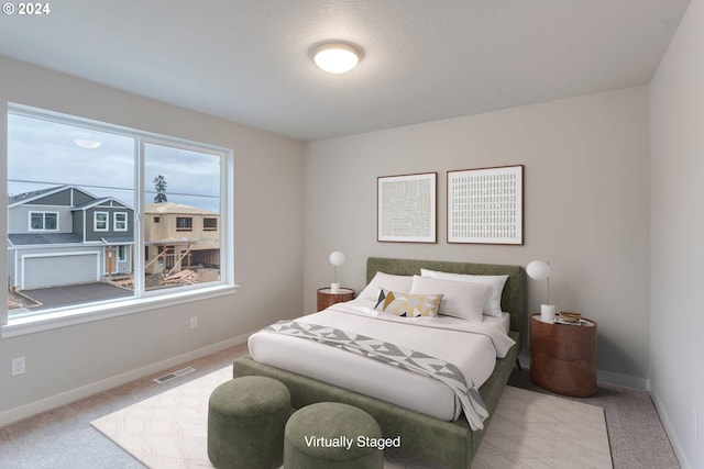 bedroom featuring light carpet