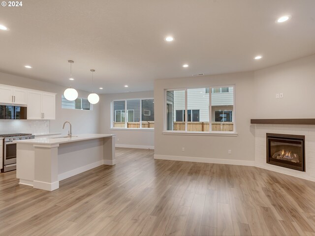 living room with sink and light wood-type flooring