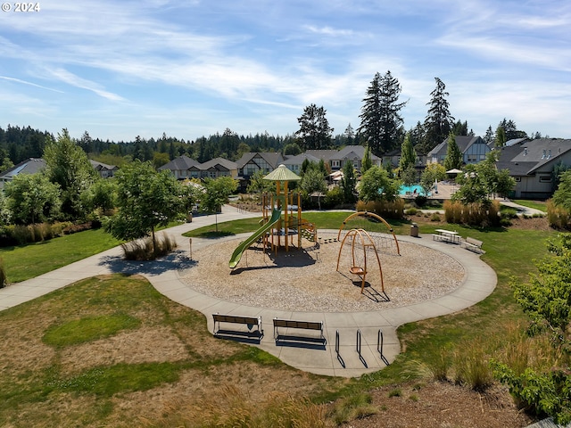 view of property's community with a lawn and a playground