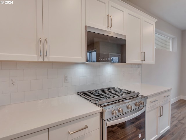 kitchen featuring backsplash, wood-type flooring, stainless steel range with gas stovetop, and white cabinets